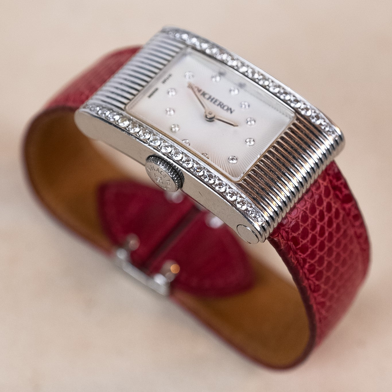 Boucheron Reflet Lady watch in 34 X 21 mm steel case with a diamonds-paved bezel powered by a quartz movement on an interchangeable leather strap 3/4 angle view