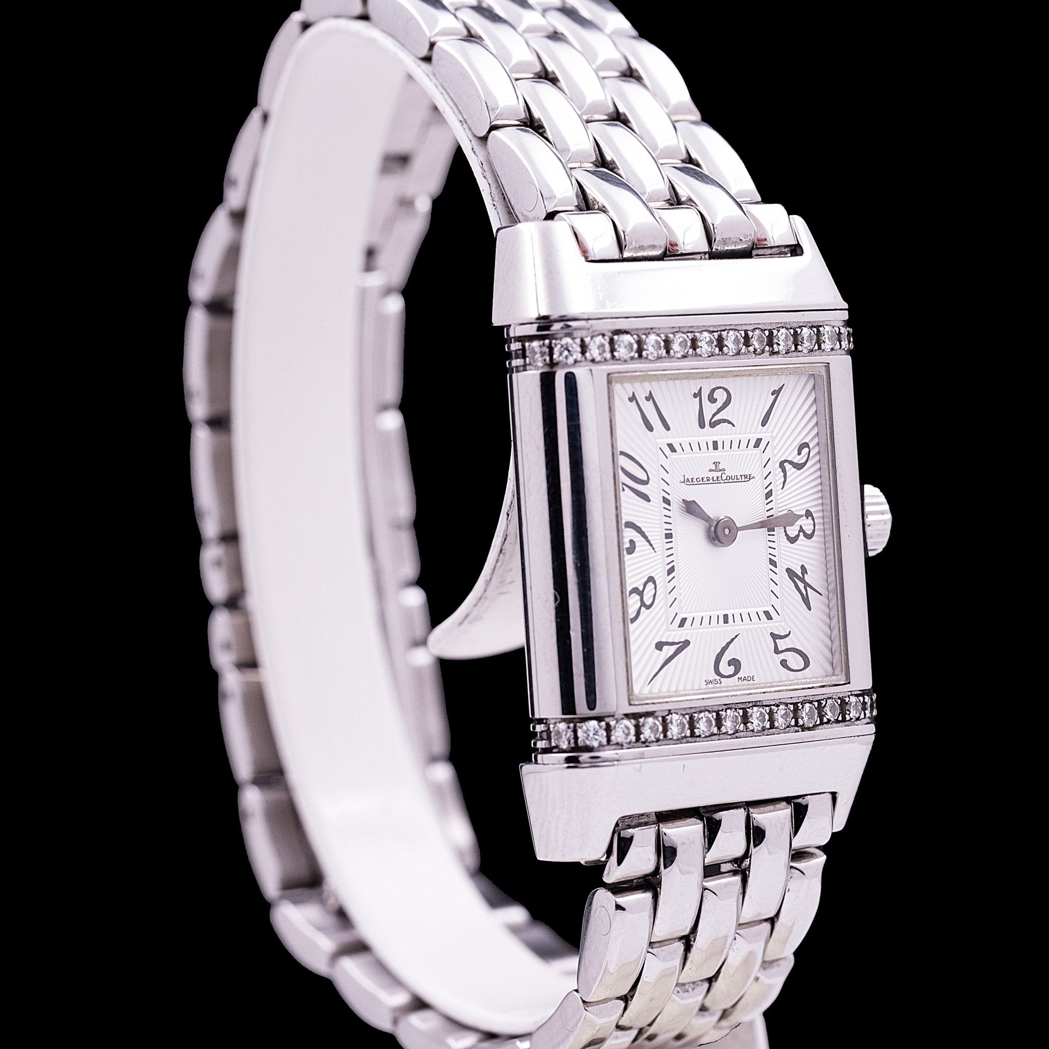 Jaeger-LeCoultre Reverso Lady Steel and Diamonds reference 265.8.08, quartz movement, reversible steel case 21 x 33 mm, upper and lower lugs set with diamonds, silver sunburst guilloché dial, stylised Arabic numerals, original steel rice-grain bracelet, 2000s