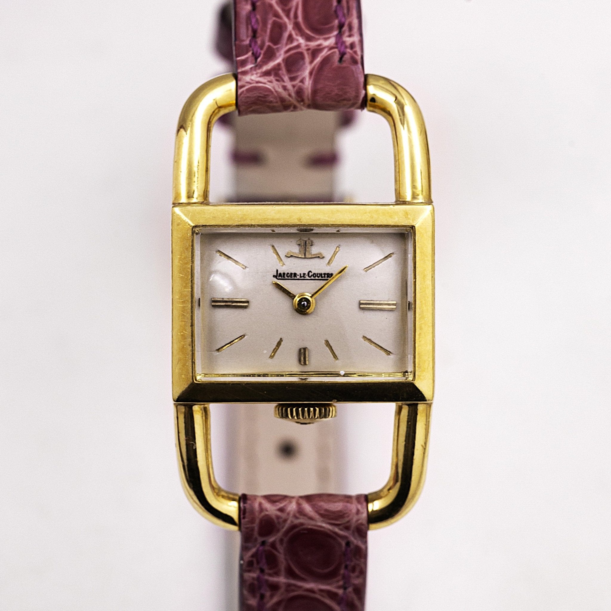 Jaeger-LeCoultre Étrier in 18-carat yellow gold, 1960s. Shaped case with stirrup lugs, silver dial, crown at 6 o'clock. Serviced and warranted by Contre-Temps.