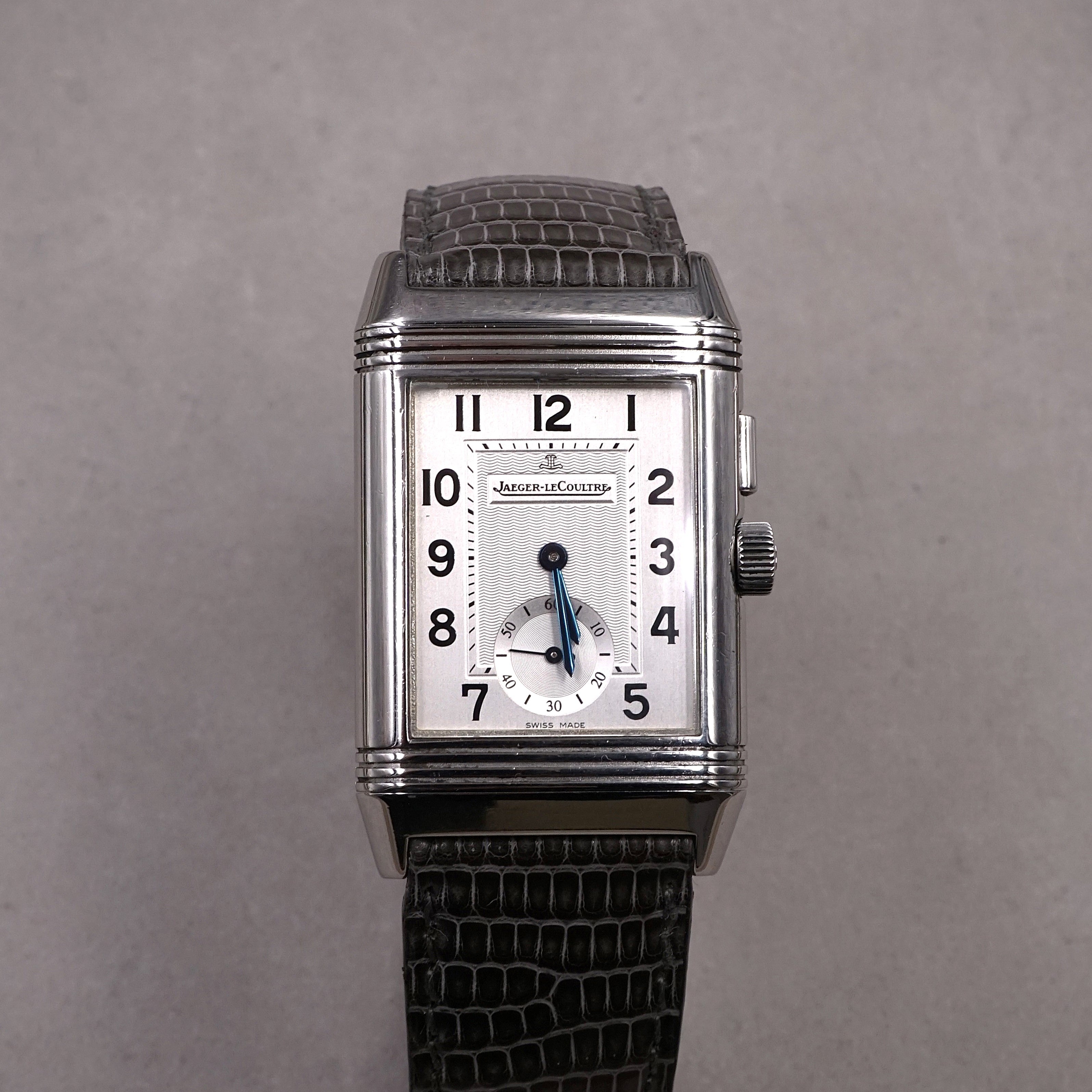 Jaeger-Lecoultre Reverso Night & Day vintage watch in steel with 2 time zones and hand wound movement on leather strap with original folding clasp silver face view