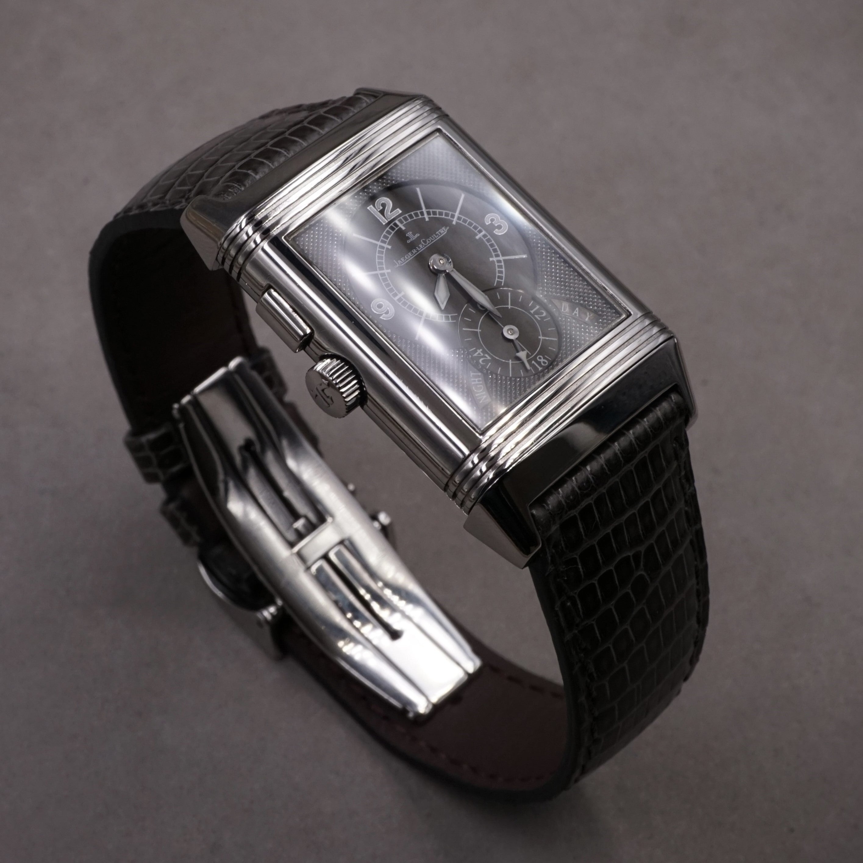 Jaeger-Lecoultre Reverso Night & Day vintage watch in steel with 2 time zones and hand wound movement on leather strap with original folding clasp night face 3/4 view