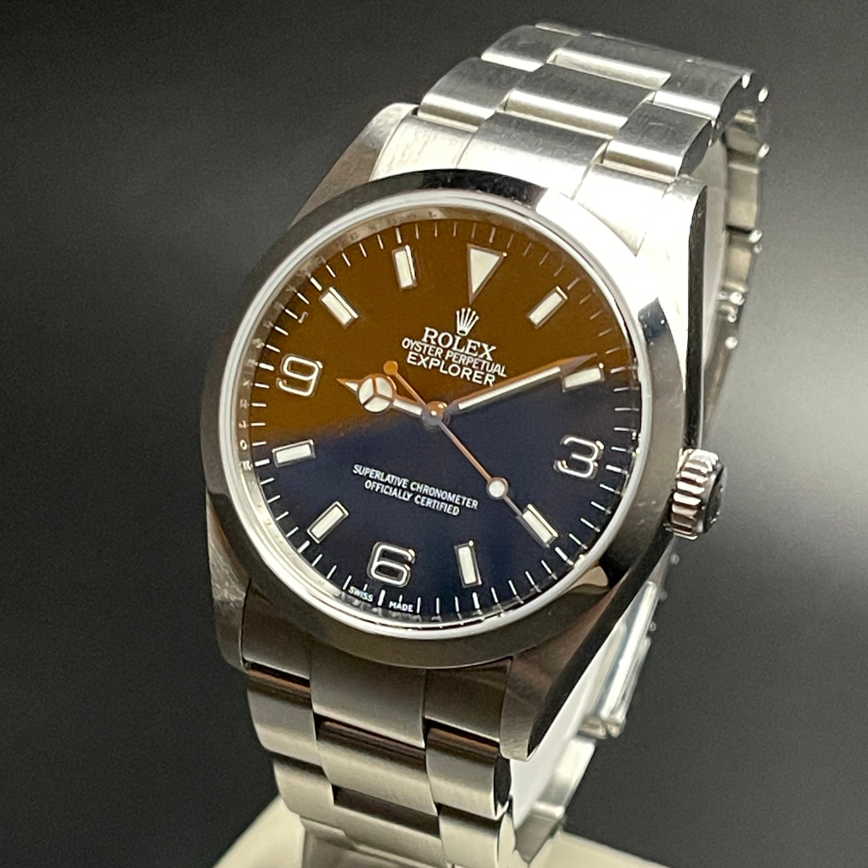 Rolex Explorer I vintage self-winding watch ref 114270 in 36 mm steel case on Oyster strap from 2002 on stand view