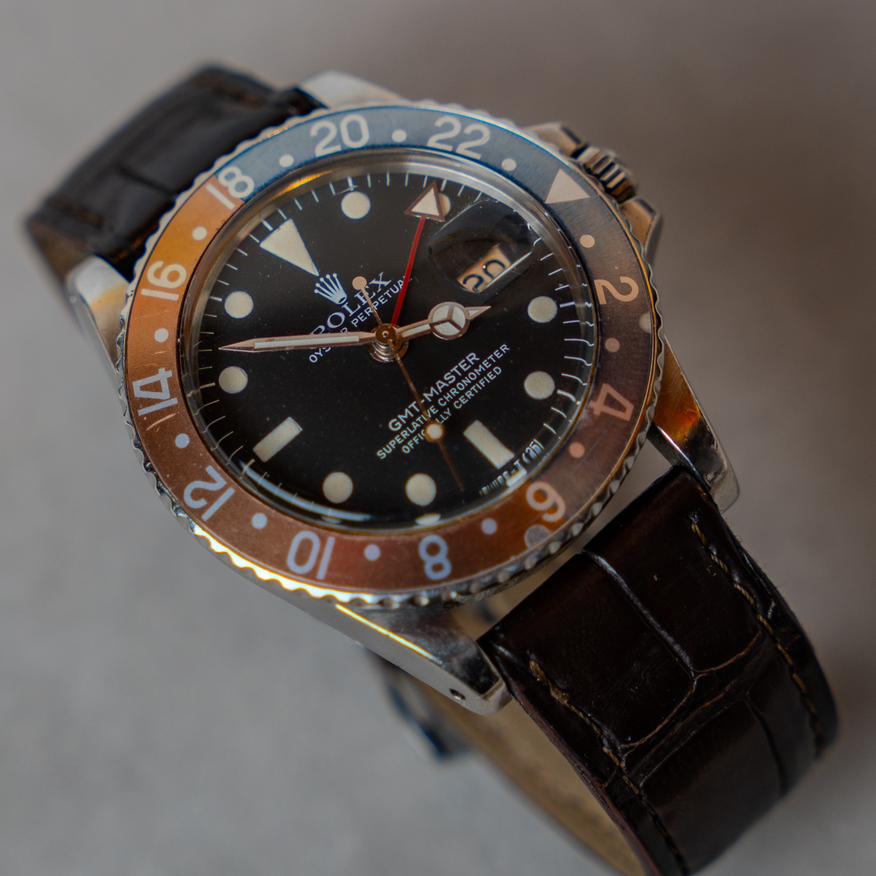 Rolex GMT Master "Pepsi" ref 1675 with rare intense patina red and blue bezel on leather strap from 1967 3/4 angle view