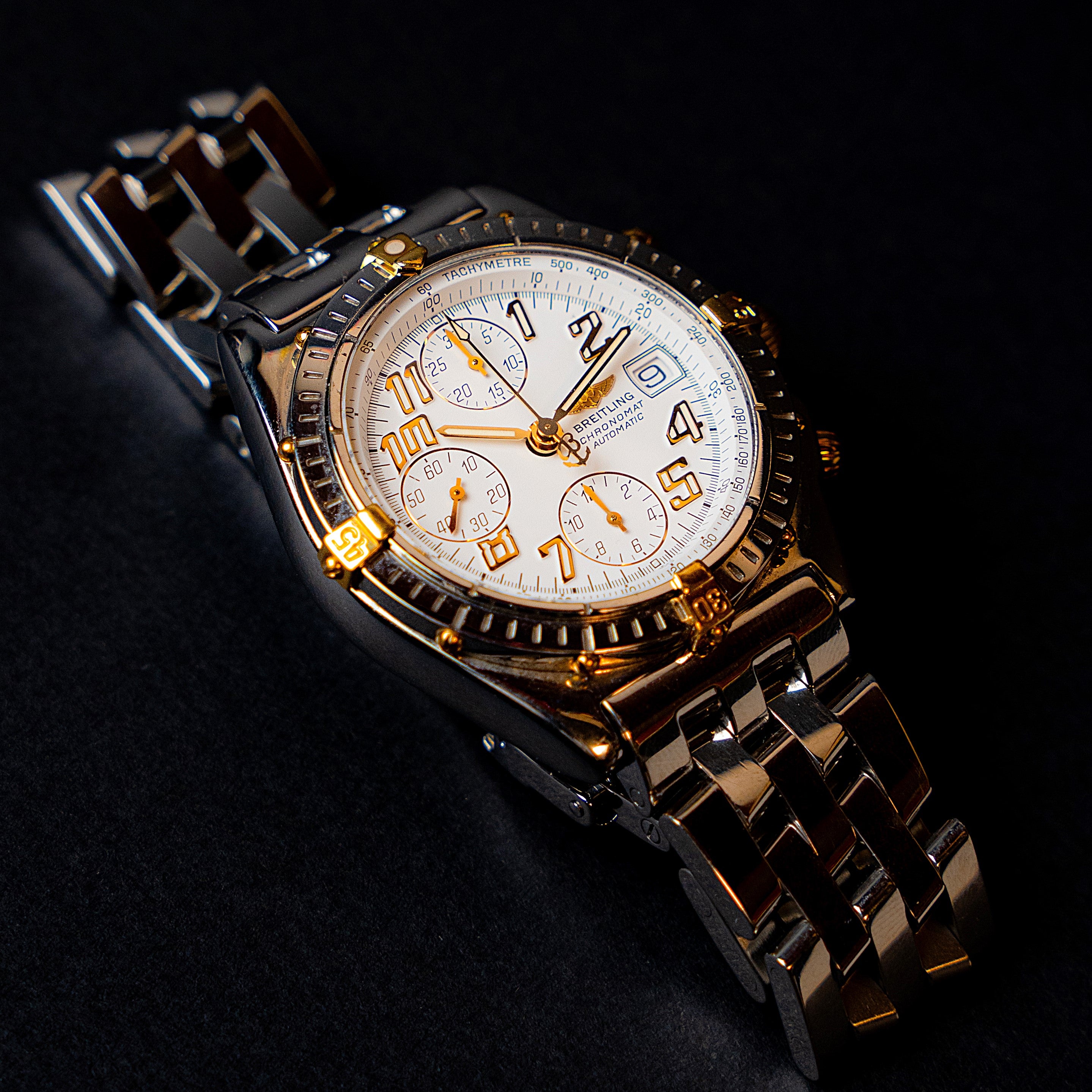 Breitling Chronomat Automatic vintage chronograph from the 90's in two-tone steel and 18 carat gold featuring a crisp white dial with gold indices, large Arabic numerals and hands with its rare original bracelet and signed double-folding clasp 3/4 view