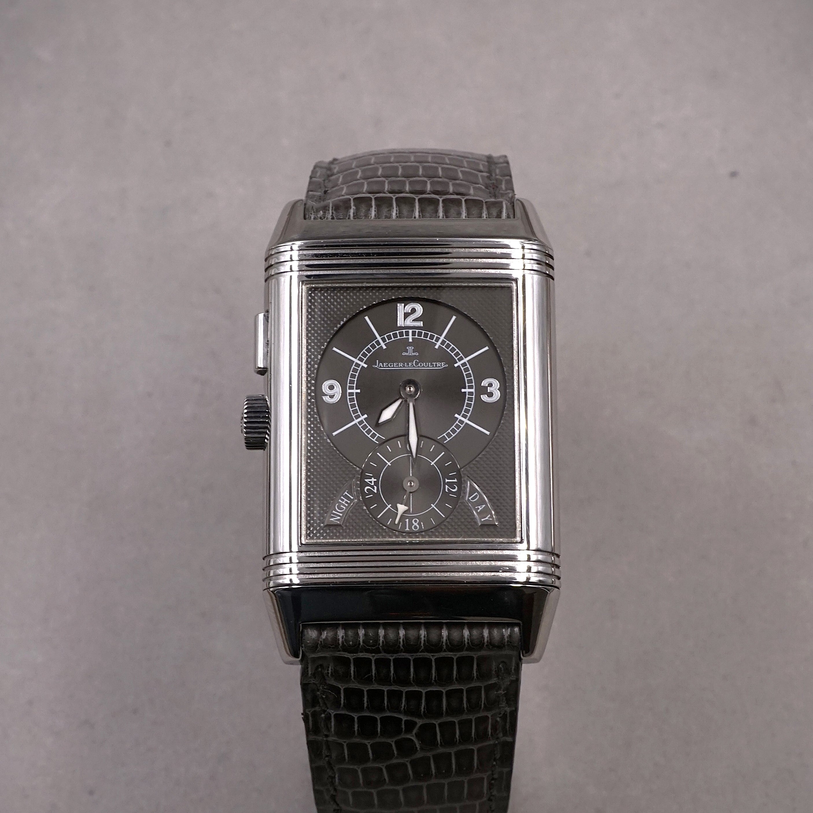 Jaeger-Lecoultre Reverso Night & Day vintage watch in steel with 2 time zones  and hand wound movement on leather strap with original folding clasp silver night face view 